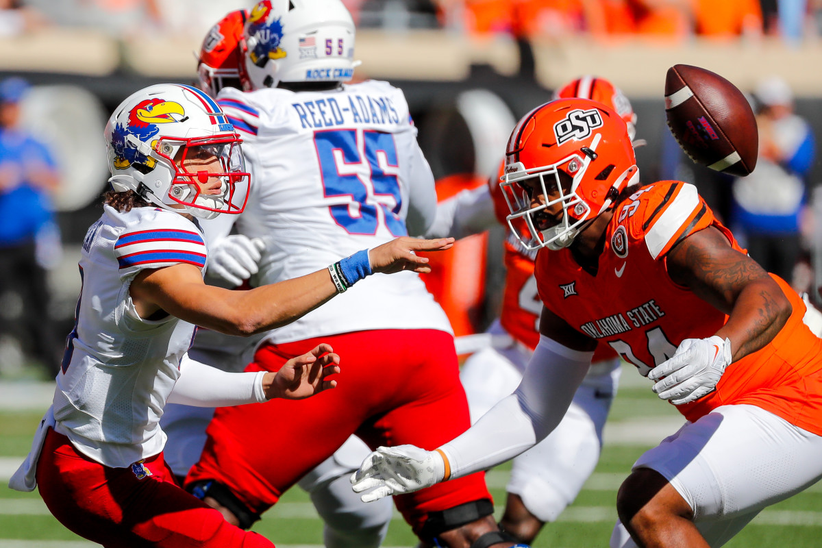 Oct 14, 2023; Stillwater, Oklahoma, USA; Kansas Jayhawks s Jason Bean (9) pitches the ball in the first quarter against the Oklahoma State Cowboys at Boone Pickens Stadium.